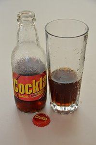 Cockta_in_bottle_and_glass_with_cap.jpg